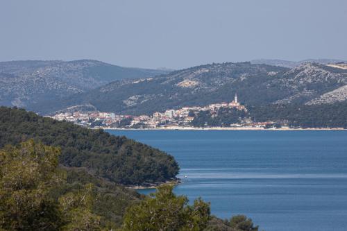 a view of a large body of water with mountains at Villas Residence 360 in Trogir