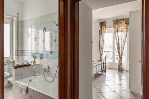 a bathroom with a bath tub and a sink at A Casa Scipione in Formia