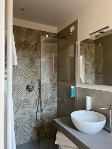 a bathroom with a white sink and a shower at Hotel Garden in Fino del Monte