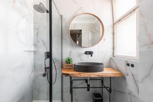 a bathroom with a sink and a mirror at New modern apartment 5. floor in Prague