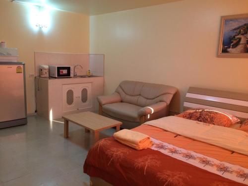 a bedroom with a bed and a couch and a table at SK Muang Thong Thani in Bangkok