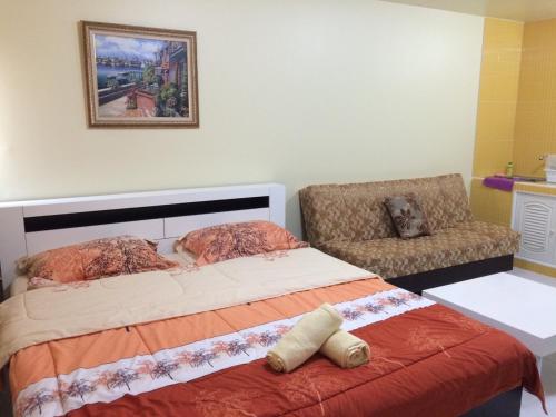Un pat sau paturi într-o cameră la SK Muang Thong Thani