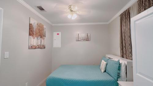 a bedroom with a blue bed in a room at 310 Priscilla Dr Apartment in Fort Walton Beach