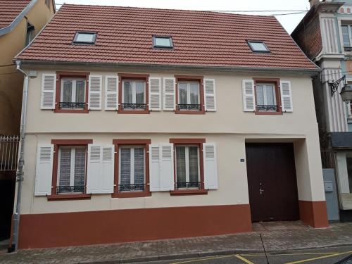 a house with white shutters and a red roof at appartement 2-3 pièce in Pfaffenhoffen