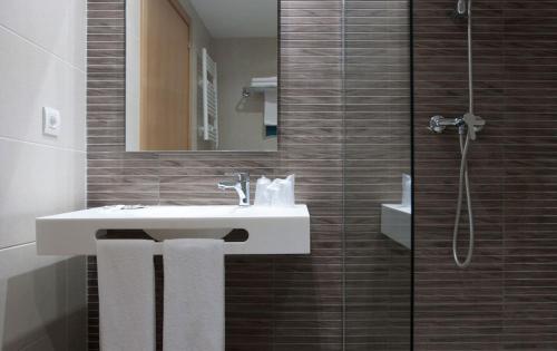 a bathroom with a sink and a shower at Hotel Montesol Benidorm in Benidorm