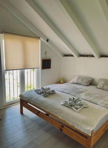 a bedroom with a large bed with two flowers on it at Villa SARA in Postira