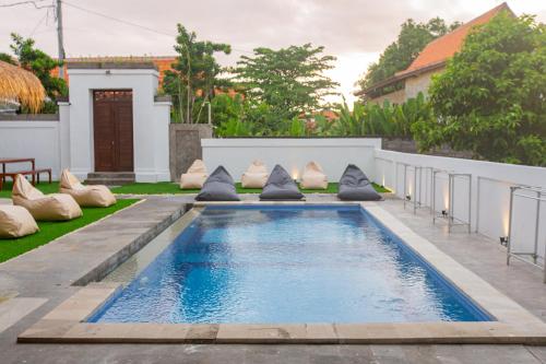 a swimming pool in the backyard of a house at Zentiga Surf Hostel in Canggu