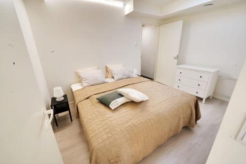 a white bedroom with a large bed with two pillows at 3h,k,p - Keskellä Tamperetta kaunis parvekkeellinen uusittu kolmio in Tampere