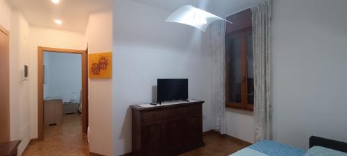 a room with a tv on a dresser with a bed at A casa di Mirco in Viverone