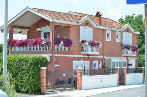 a house with flower boxes on the balconies at Apartmani LANA Podgorica in Podgorica