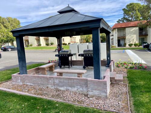 a gazebo with a picnic table and a bench at Desert Getaway in Desert Hot Springs