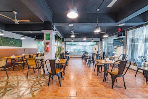 a restaurant with tables and chairs in a room at Hotel Athome , Whitefields, Kondapur in Hyderabad
