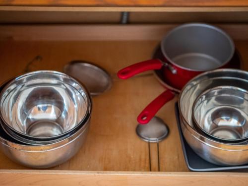 a drawer with a cup and two pans and a tea pot at Home oasis with sauna, jacuzzi, pool & heated gazebo! in Clovis