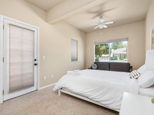 a bedroom with a bed and a window at Home oasis with sauna, jacuzzi, pool & heated gazebo! in Clovis
