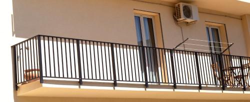 a balcony of a building with a iron railing at Appartamento Castel Sant'Angelo in Licata
