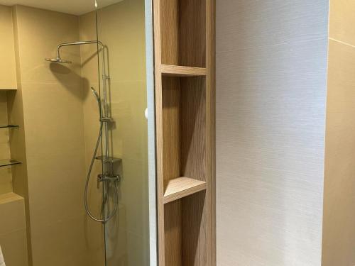 a shower in a bathroom with a glass door at Brand new Condo in Laguna near golf course in Bang Tao Beach