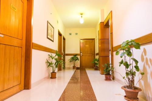 a hallway with potted plants in a building at Private Room near Istanbul Airport 4 in Arnavutköy