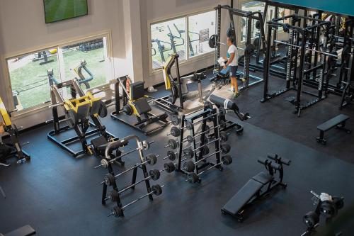 a woman in a gym with several tread machines at Prime Select New Giza in Giza