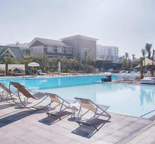 a group of chairs and a swimming pool at Prime Select New Giza in Giza
