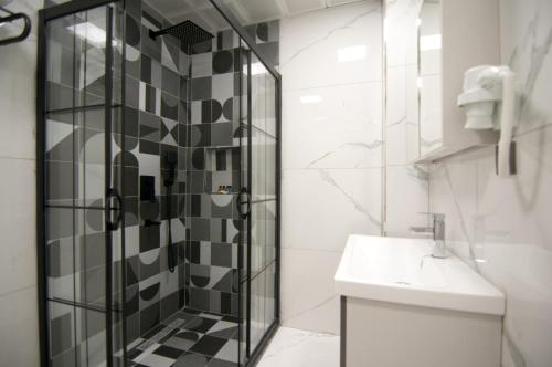 a bathroom with a shower and a toilet and a sink at Paris Garden Hotel Istanbul in Istanbul