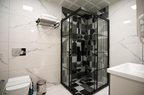a bathroom with a shower and a toilet and a sink at Paris Garden Hotel Istanbul in Istanbul