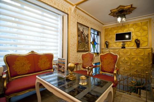 a living room with two chairs and a glass table at Paris Garden Hotel Istanbul in Istanbul