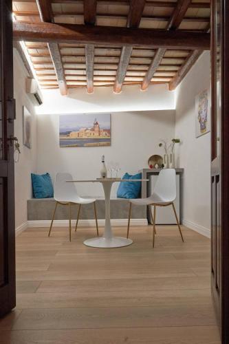 a dining room with a table and two chairs at Residence Cortile Mercè in Trapani