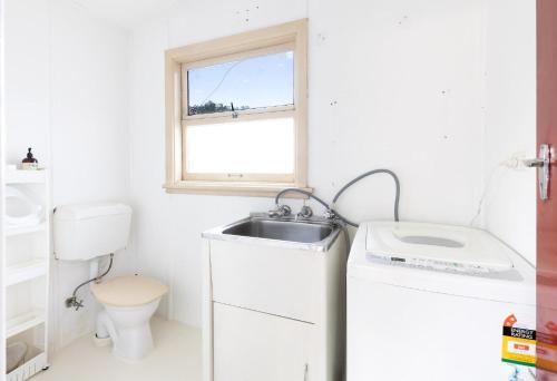 a small bathroom with a sink and a toilet at Work from country side with urban amenities in Kurmond