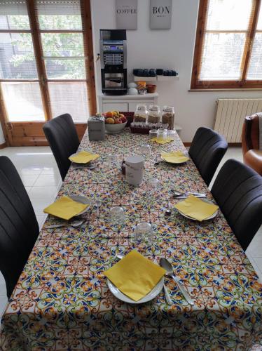 a table with yellow napkins and chairs around it at Alle Terme B&B in Rapolano Terme