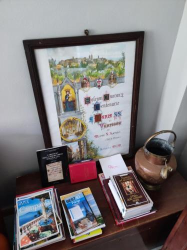 a table with a picture and books on it at Alle Terme B&B in Rapolano Terme
