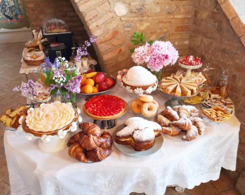 a table with various pastries and desserts on it at Agriturismo le Fontanelle da Valente in Montichiari
