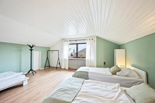 two beds in a room with a white ceiling at Sali Homes - SchaefersNest in Obersulm