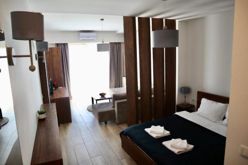 a bedroom with a bed with two towels on it at PS Apartments in Ohrid