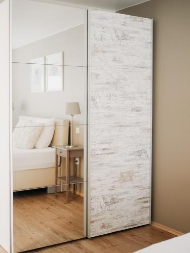 a sliding glass door in a bedroom with a bed at Appartement Meyer-Ernzen in Echternach