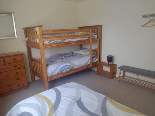 a bedroom with two bunk beds and a bed at Swilly Cottage, Portstewart in Portstewart