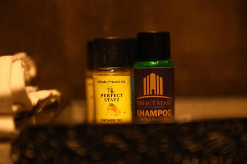 two bottles of mustard and shampoos sitting on a counter at Perfectstayz Premium Ganga Heights at Harkipauri Road in Haridwār