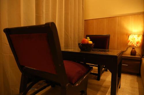 a room with a table with a bowl of fruit on it at Perfectstayz Premium Ganga Heights at Harkipauri Road in Haridwār