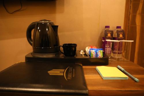 a coffee pot sitting on top of a counter at Perfectstayz Premium Ganga Heights at Harkipauri Road in Haridwār