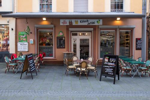 a restaurant with tables and chairs in front of it at Haus Moselwelt - Tilda in Zell an der Mosel