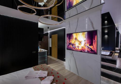 a living room with a tv on a wall at Wiślane Tarasy VIP Apartamenty JACUZZI in Kraków