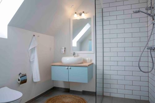 a bathroom with a sink and a mirror at Hjerting Badehotel in Esbjerg