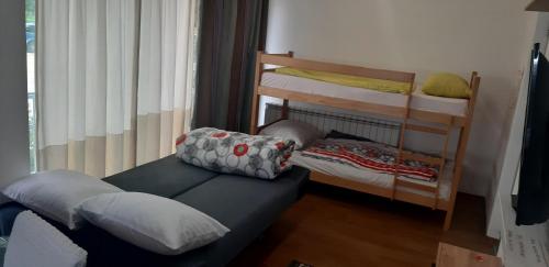 a room with a bed and bunk beds in it at Aprtments Belma in Sarajevo
