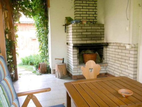 a living room with a brick fireplace and a wooden table at Dřevěnice u Azzyho in Lačnov