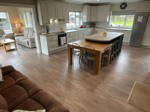 a kitchen and living room with a table and a couch at Ballylee in Galway