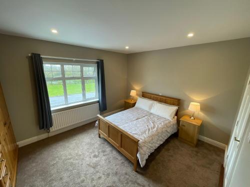 a bedroom with a bed and a large window at Ballylee in Galway