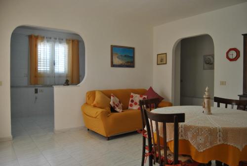 a living room with a couch and a table at LA PERGOLA in Lampedusa