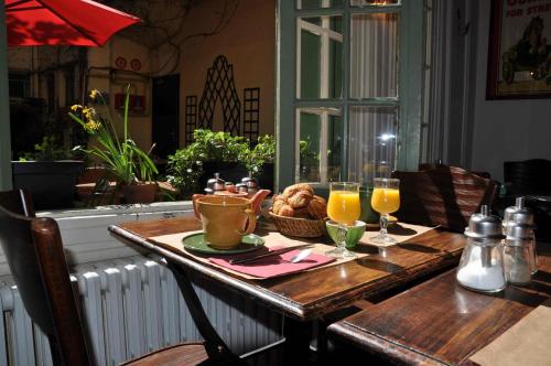 Le Vieux Carré في رووين: طاولة مع طبق من الطعام وكأسين من عصير البرتقال