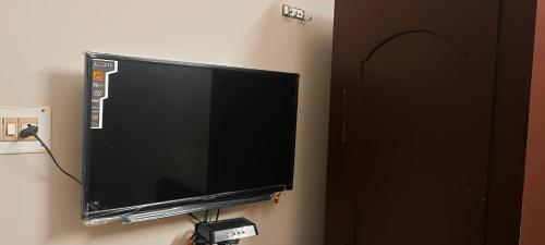 a flat screen tv hanging on a wall at CENTRAL GATE in Chennai
