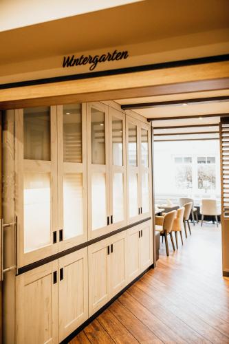 a dining room with a sign that reads wilderness kitchen at Landgasthof "Zum grünen Walde" in Nordholz