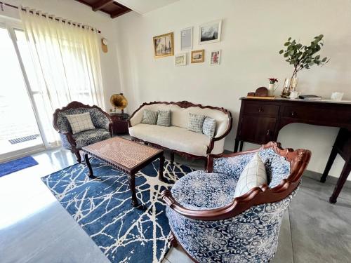 a living room with two chairs and a couch at The Heyday in Vagamon